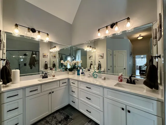 a bathroom with a granite countertop shower mirror and a sink