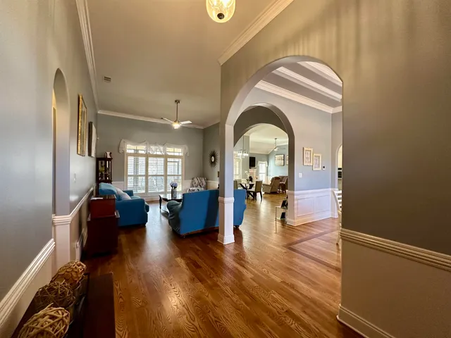 a living room with fireplace furniture and a wooden floor