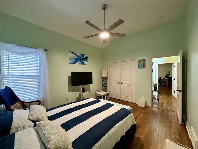 a bedroom with a bed and a flat screen tv