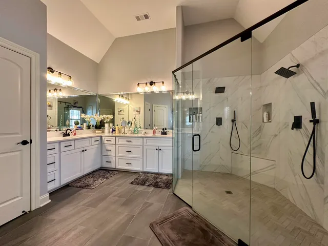 a bathroom with a granite countertop shower mirror and a sink