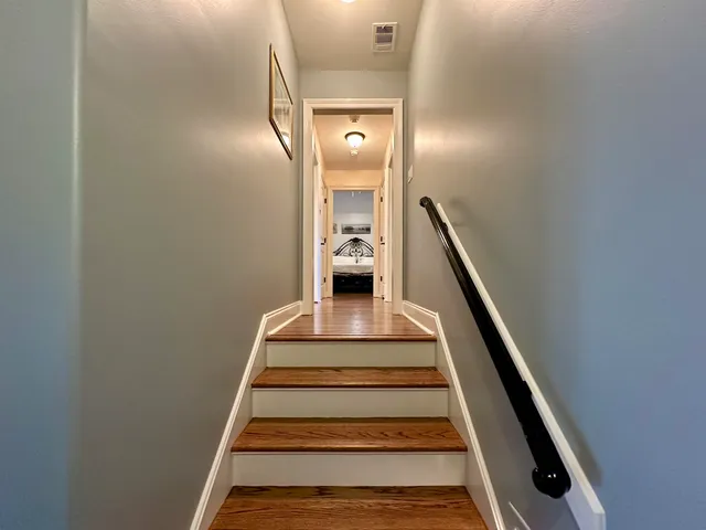 a view of entryway and hall with wooden floor