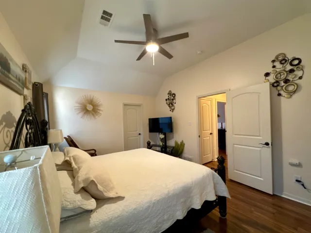 a bedroom with a bed a mirror and furniture