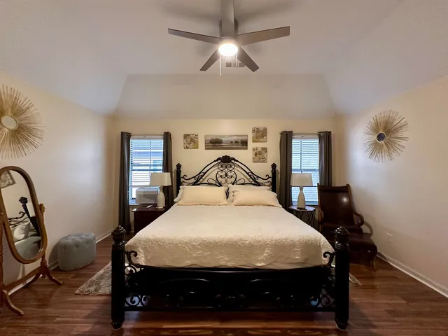 a bathroom with a sink a toilet a mirror a bathtub and shower