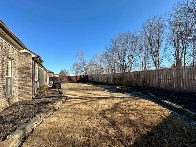 a view of street with wooden fence