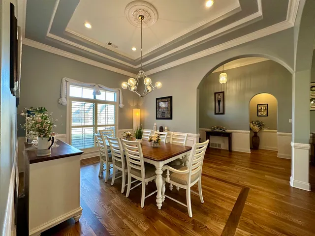 a view of a dining room with furniture and wooden floor