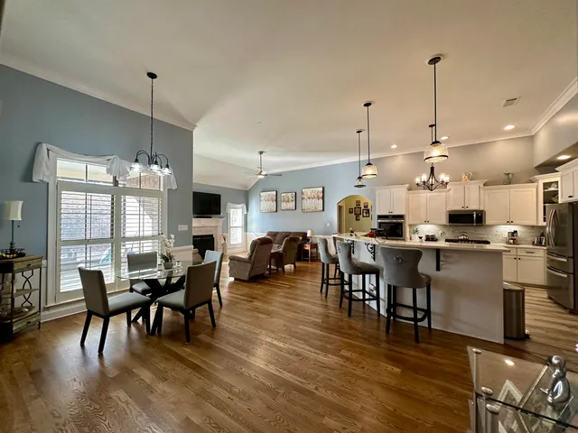 a view of a dining room with furniture window and wooden floor