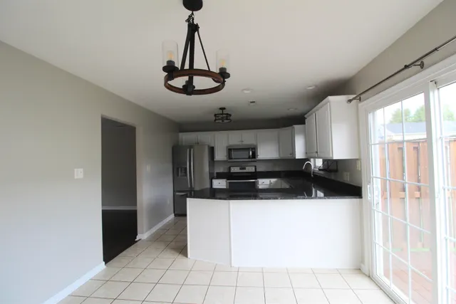 a kitchen with stainless steel appliances a counter space a sink and cabinets