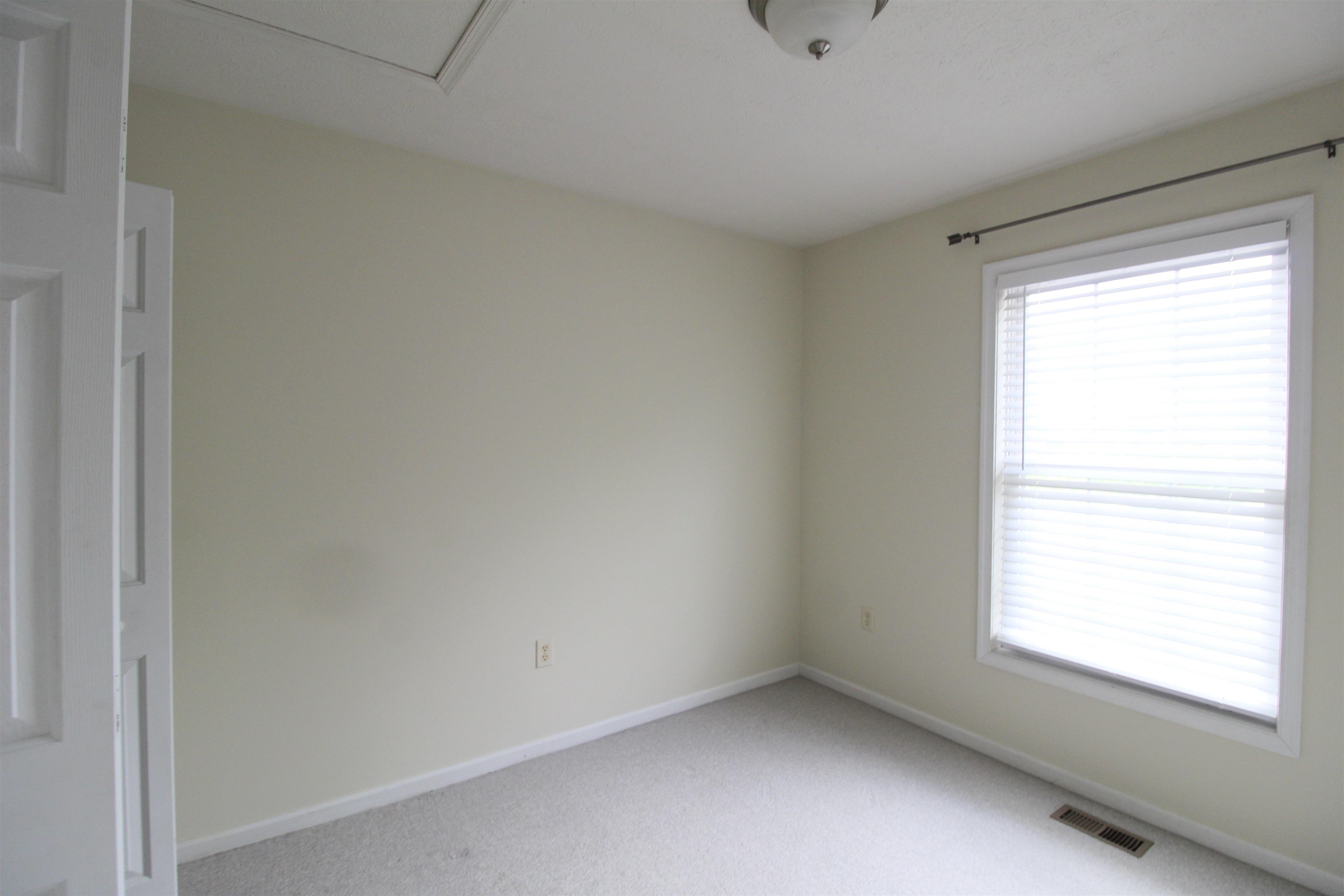 2881 Taylor Spring Lane Harrisonburg, VA 22801 - Photo 8 of 13 a view of an empty room with a window