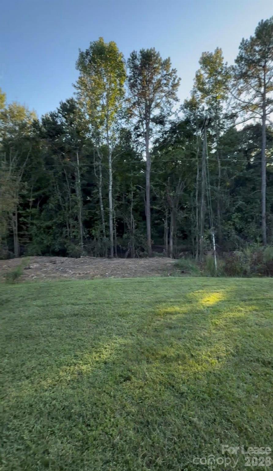 3134 Rainbow Ridge Drive Matthews, NC 28105 - Photo 11 of 12 a backyard of a house with lots of green space