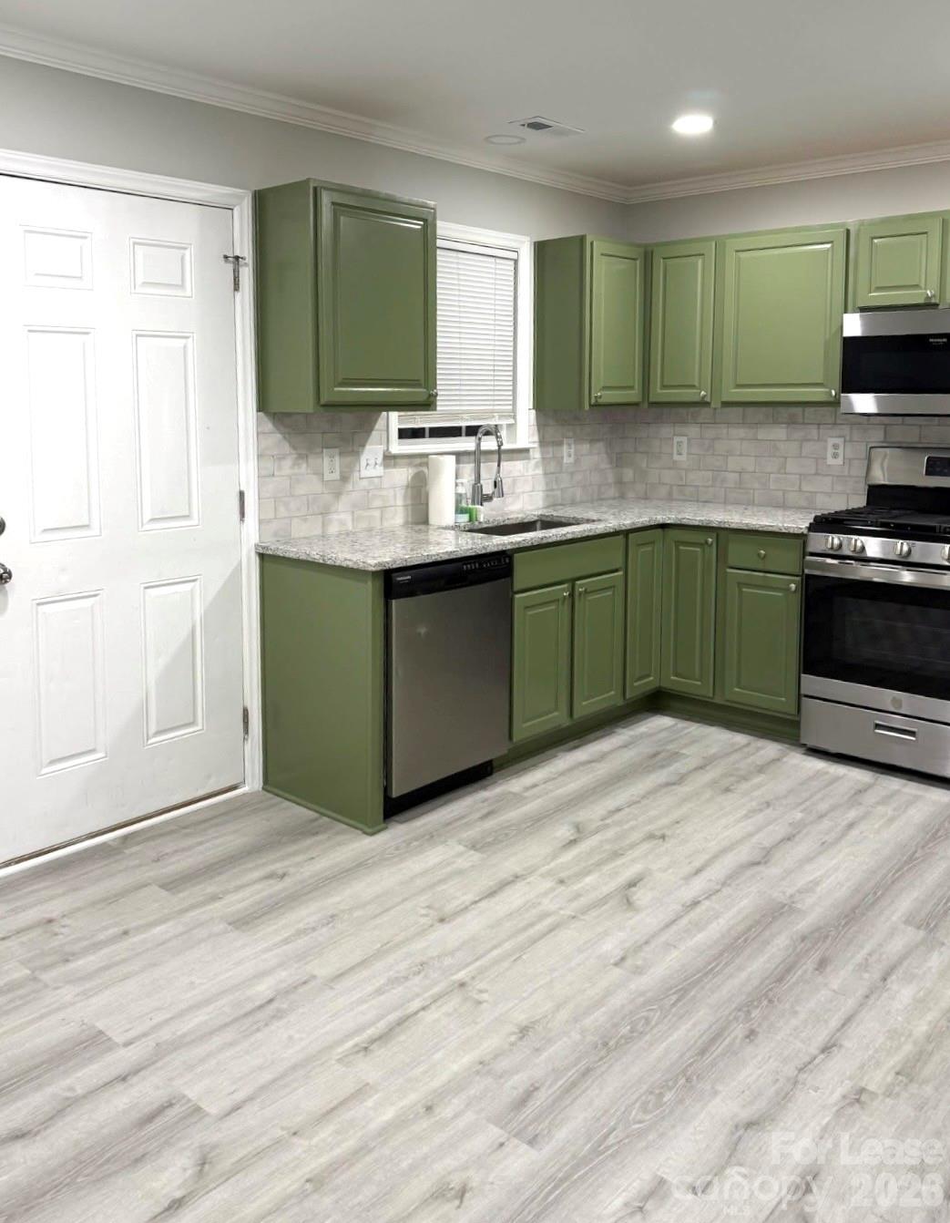 3134 Rainbow Ridge Drive Matthews, NC 28105 - Photo 4 of 12 a kitchen with granite countertop a sink cabinets and stainless steel appliances
