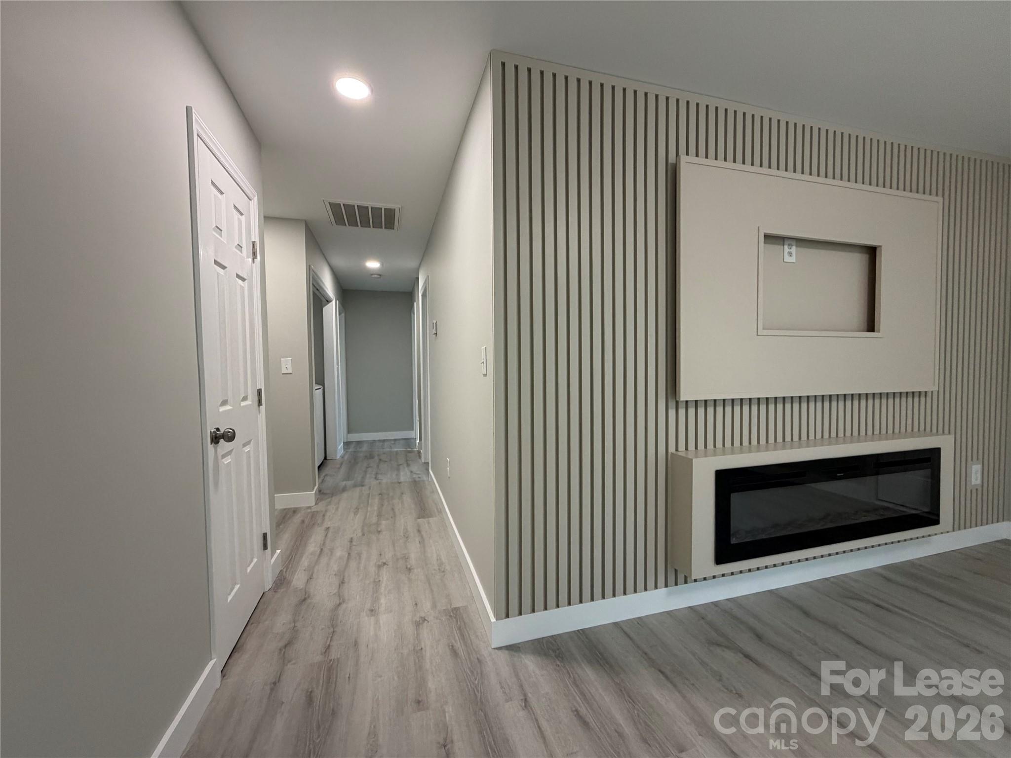 3134 Rainbow Ridge Drive Matthews, NC 28105 - Photo 5 of 12 a view of a hallway with wooden floor and staircase