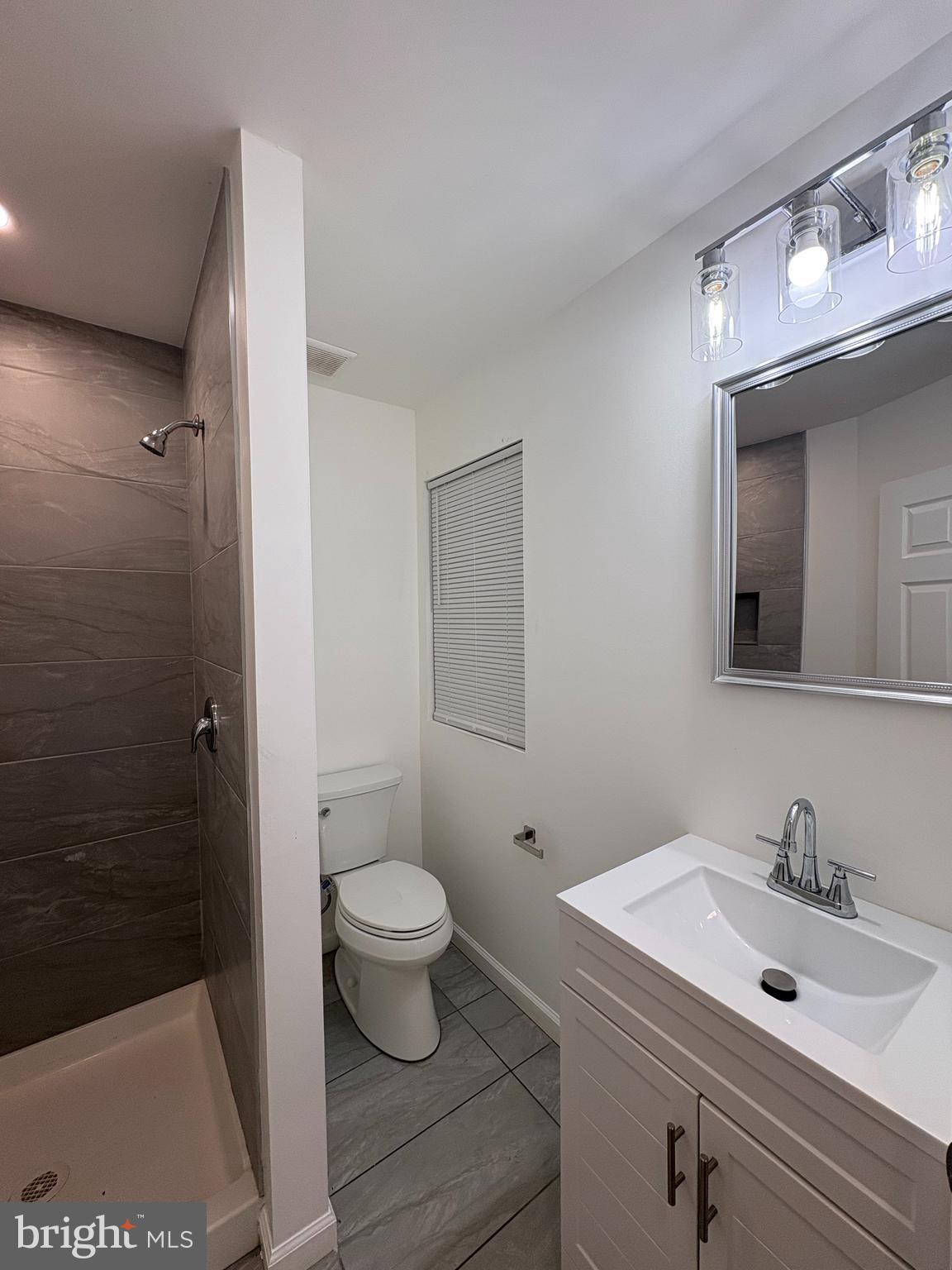 2626 North Jessup Street Philadelphia, PA 19133 - Photo 4 of 12 a bathroom with a sink a toilet a mirror and shower