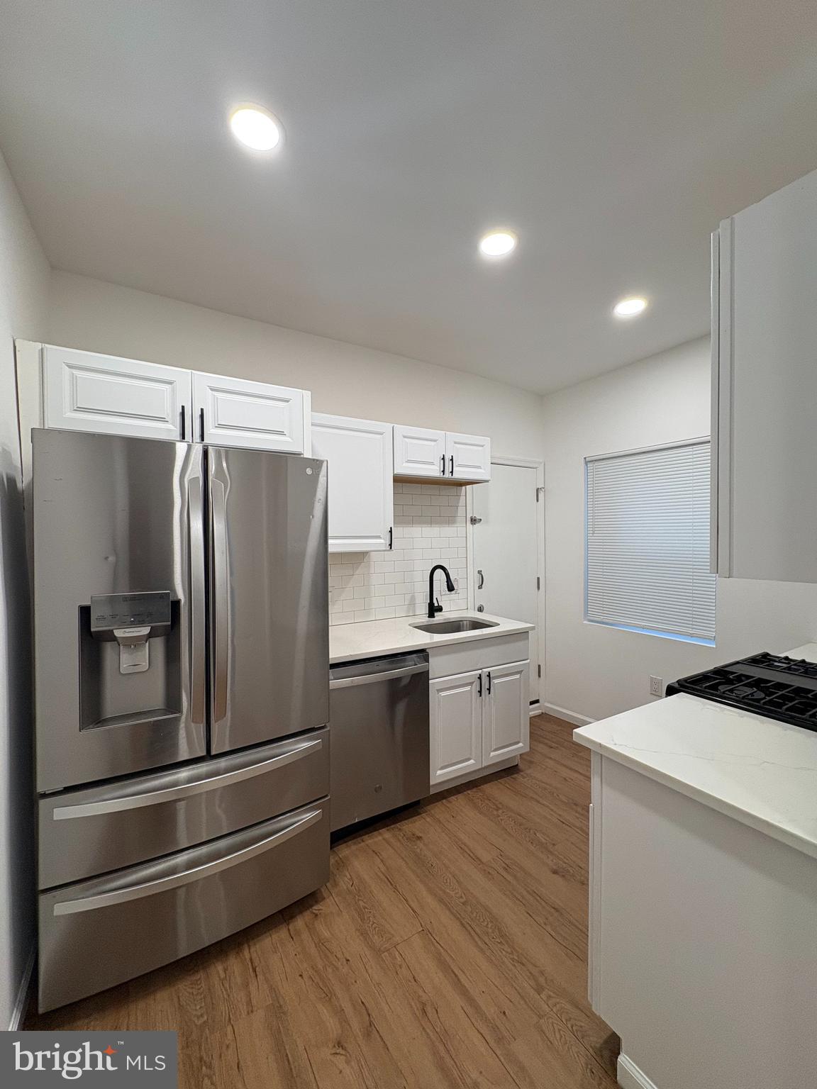 2626 North Jessup Street Philadelphia, PA 19133 - Photo 5 of 12 a kitchen with refrigerator cabinets and wooden floor