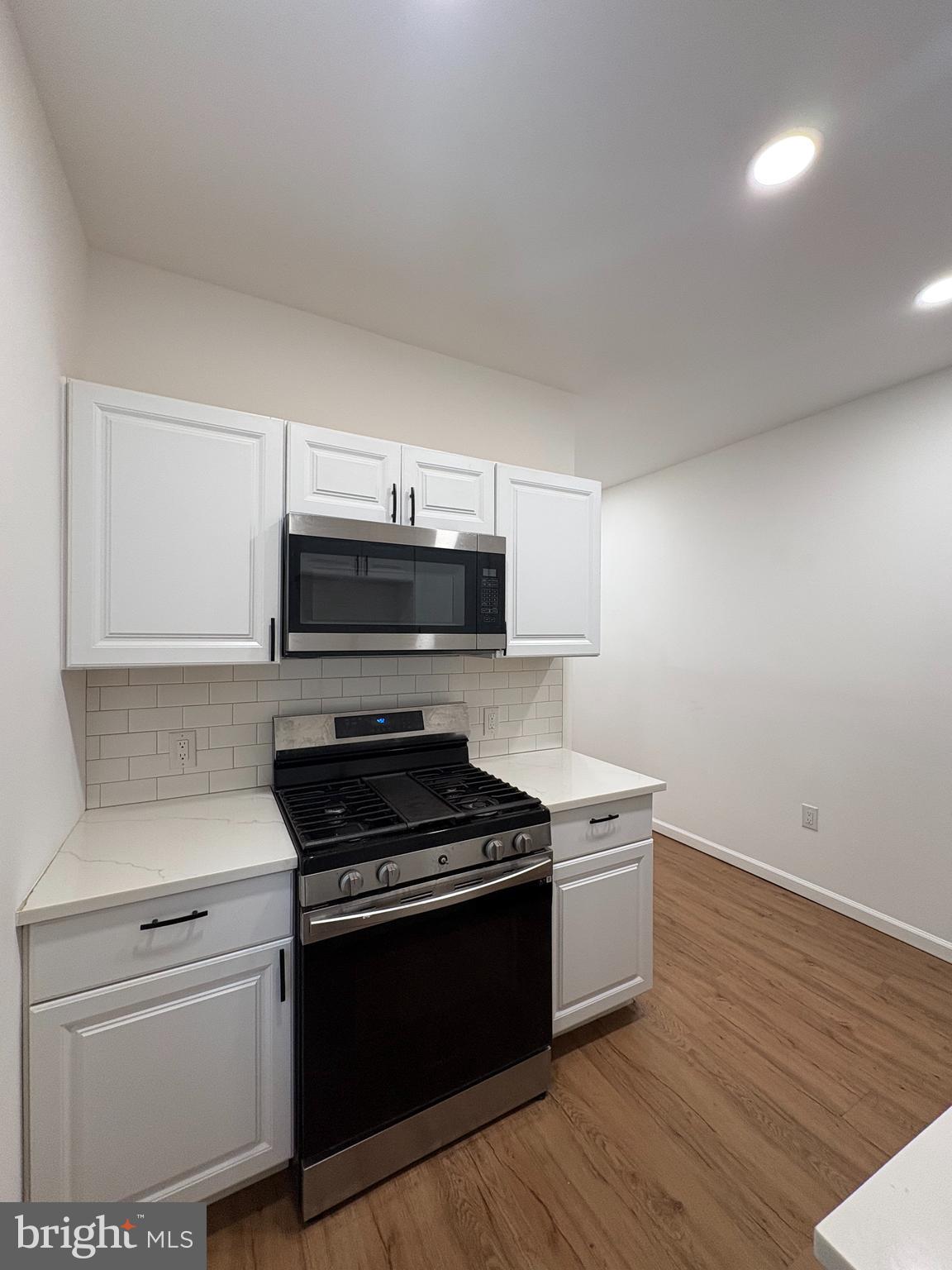 2626 North Jessup Street Philadelphia, PA 19133 - Photo 6 of 12 a kitchen with a stove and a microwave