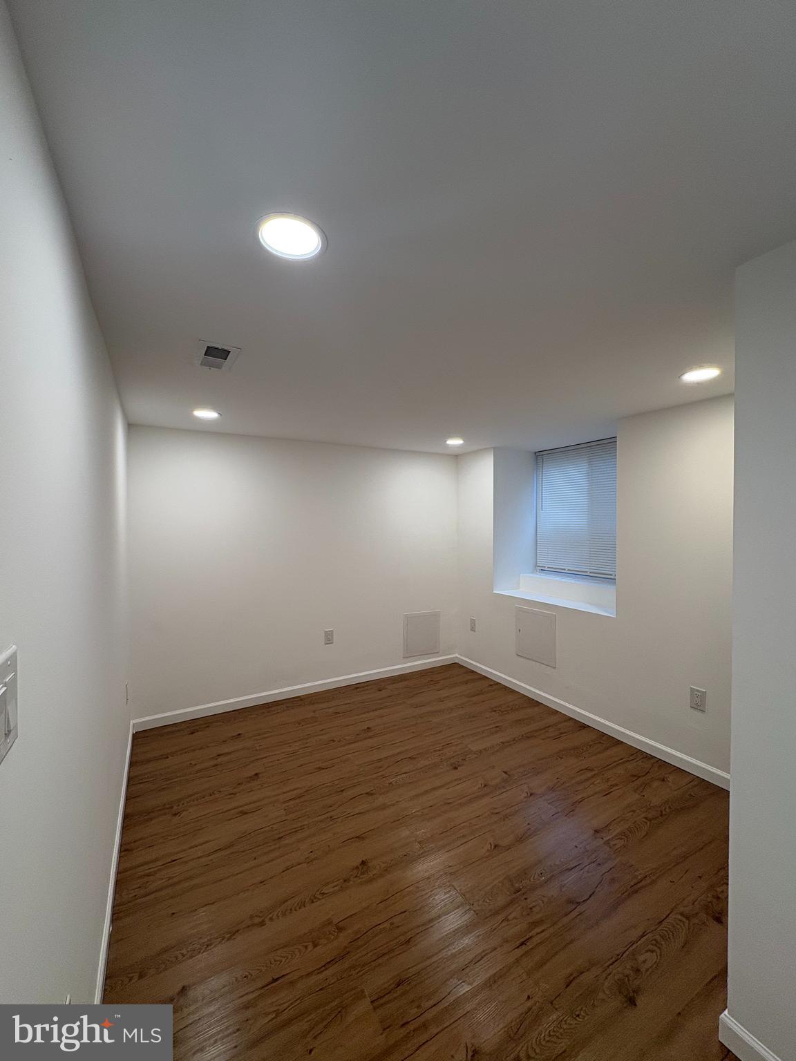 2626 North Jessup Street Philadelphia, PA 19133 - Photo 7 of 12 an empty room with wooden floor and windows