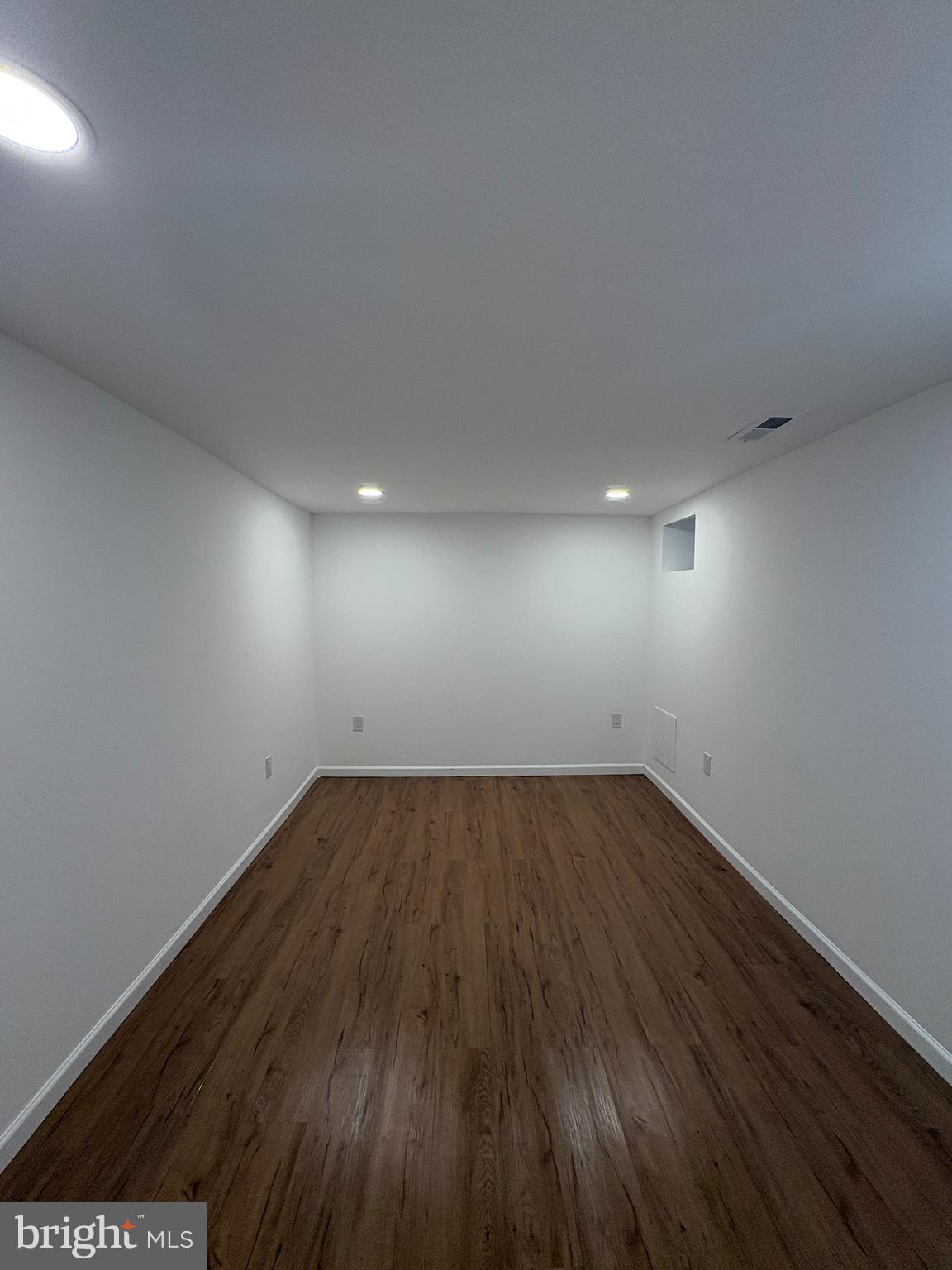 2626 North Jessup Street Philadelphia, PA 19133 - Photo 9 of 12 an empty room with wooden floor and windows