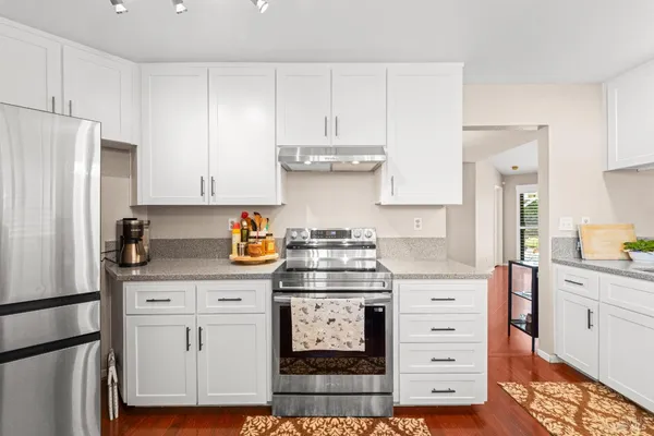 a kitchen with stainless steel appliances granite countertop a stove and a refrigerator