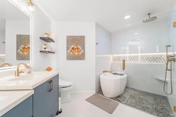 a bathroom with a sink toilet and a mirror