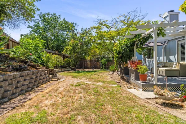 a view of a backyard with plants and patio