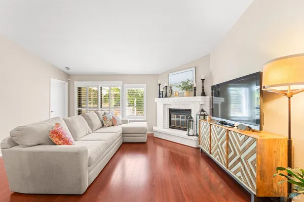 a living room with furniture a fireplace and a flat screen tv