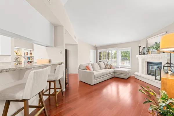 a living room with fireplace furniture and a wooden floor