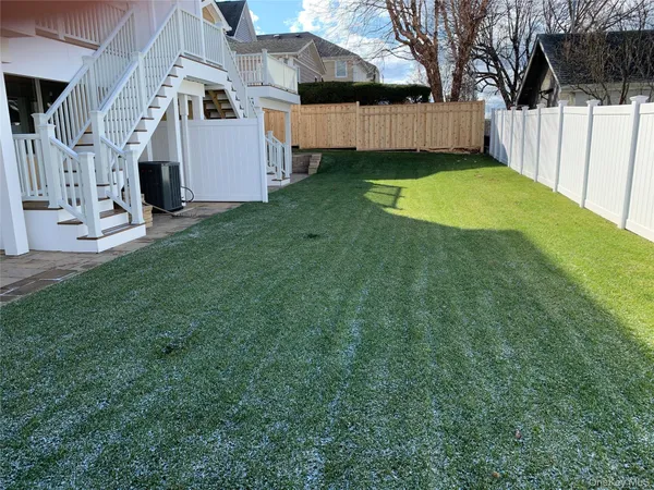 a view of backyard with a garden and deck