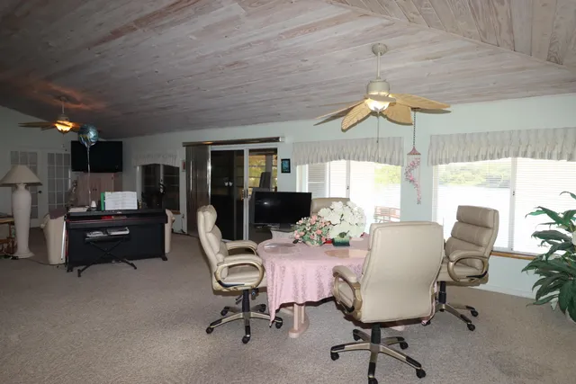 a view of a livingroom with furniture and a fan