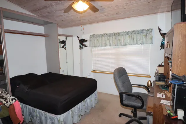 a living room with furniture a flat screen tv and a chandelier