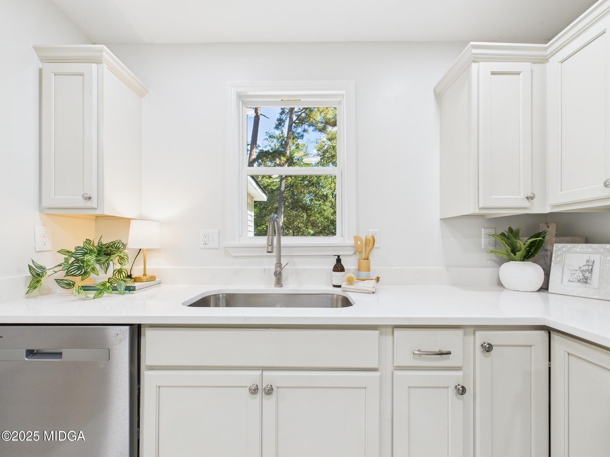 2471 Old Holton Road Macon, GA 31204 - Photo 11 of 34 a kitchen with stainless steel appliances white cabinets and a window