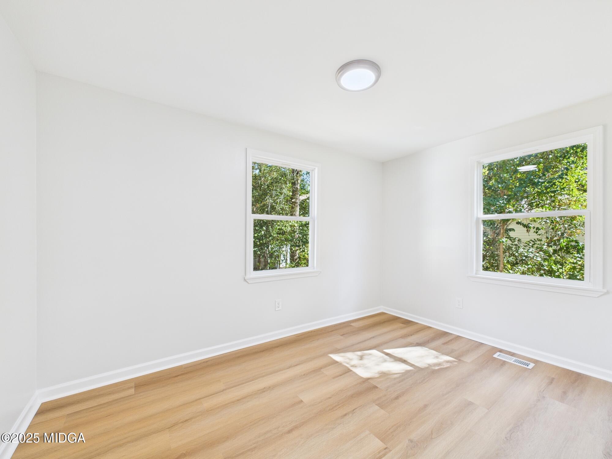 2471 Old Holton Road Macon, GA 31204 - Photo 16 of 34 an empty room with wooden floor and windows