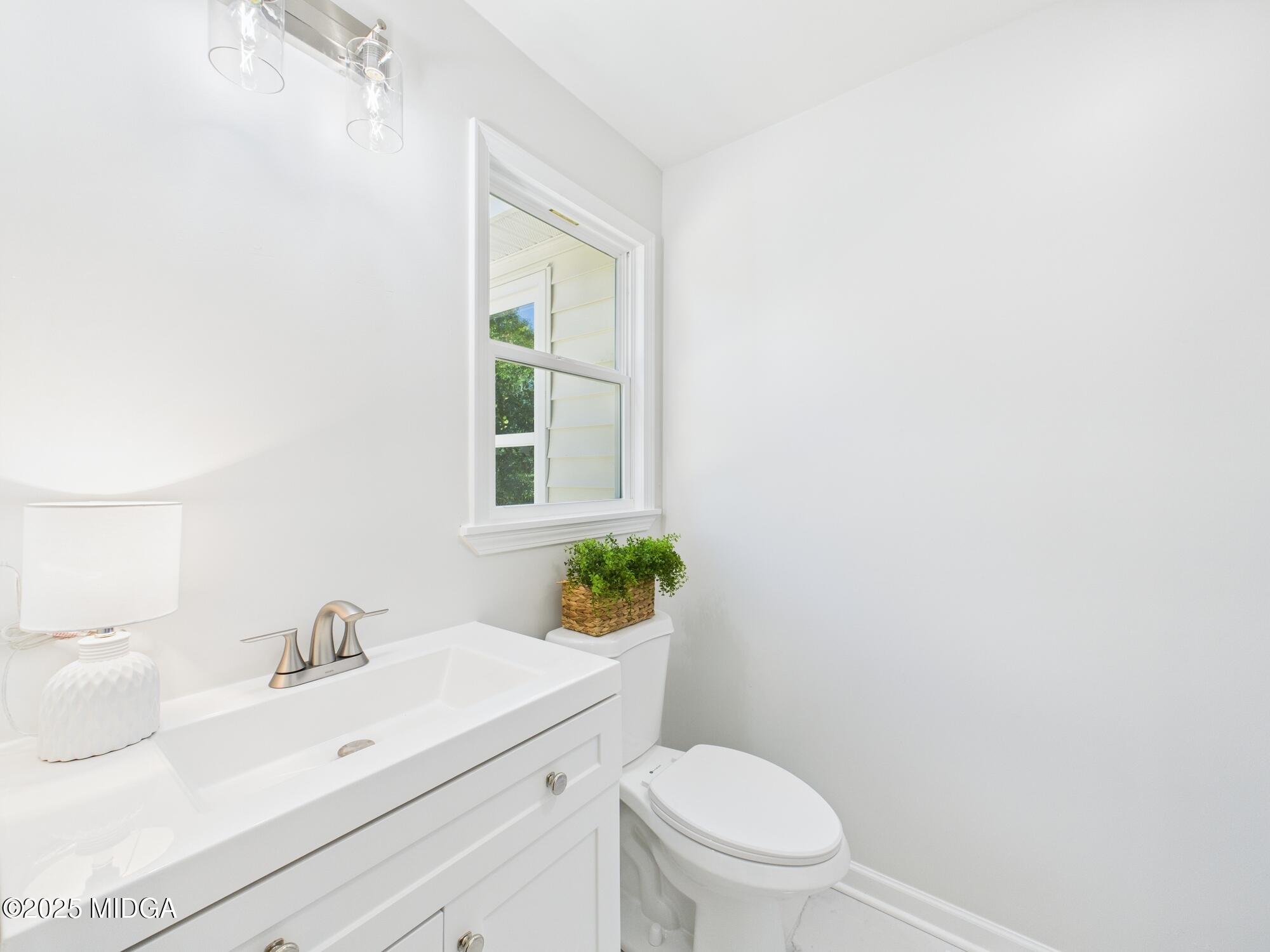 2471 Old Holton Road Macon, GA 31204 - Photo 27 of 34 a bathroom with a sink a toilet and a window