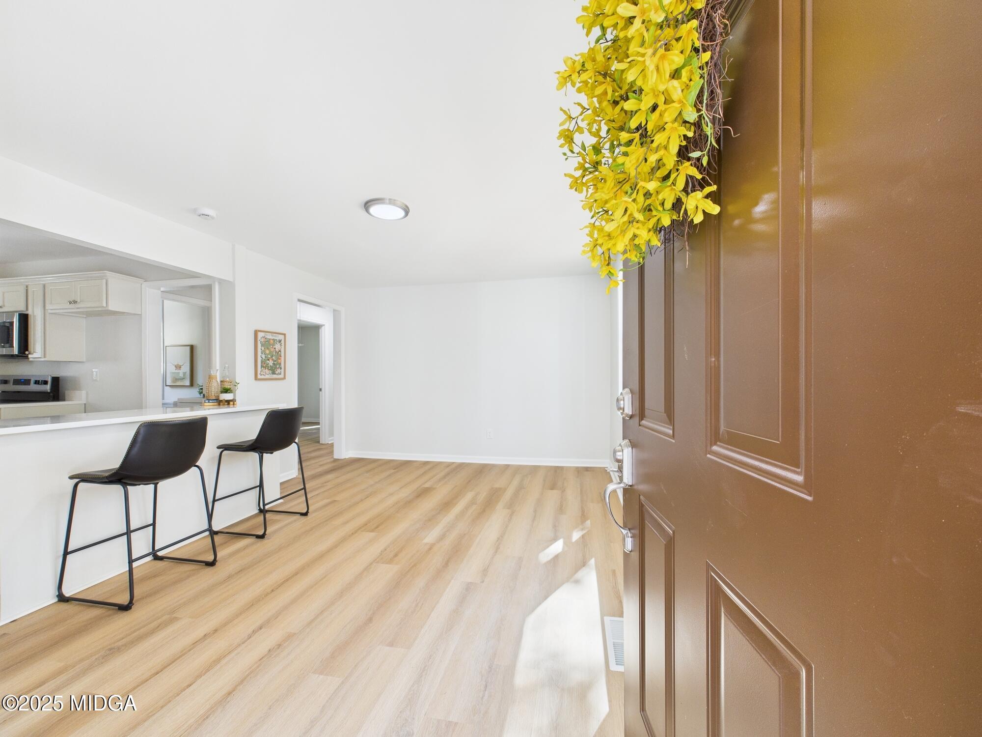 2471 Old Holton Road Macon, GA 31204 - Photo 3 of 34 a view of a room with wooden floor and a potted plant