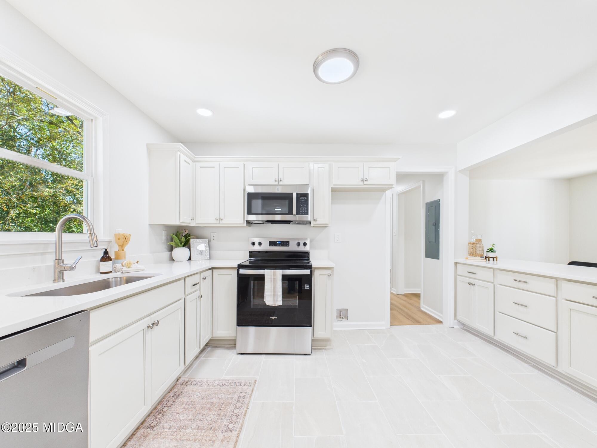 2471 Old Holton Road Macon, GA 31204 - Photo 8 of 34 a kitchen with stainless steel appliances granite countertop a stove top oven a sink a refrigerator with white cabinets and wooden floor