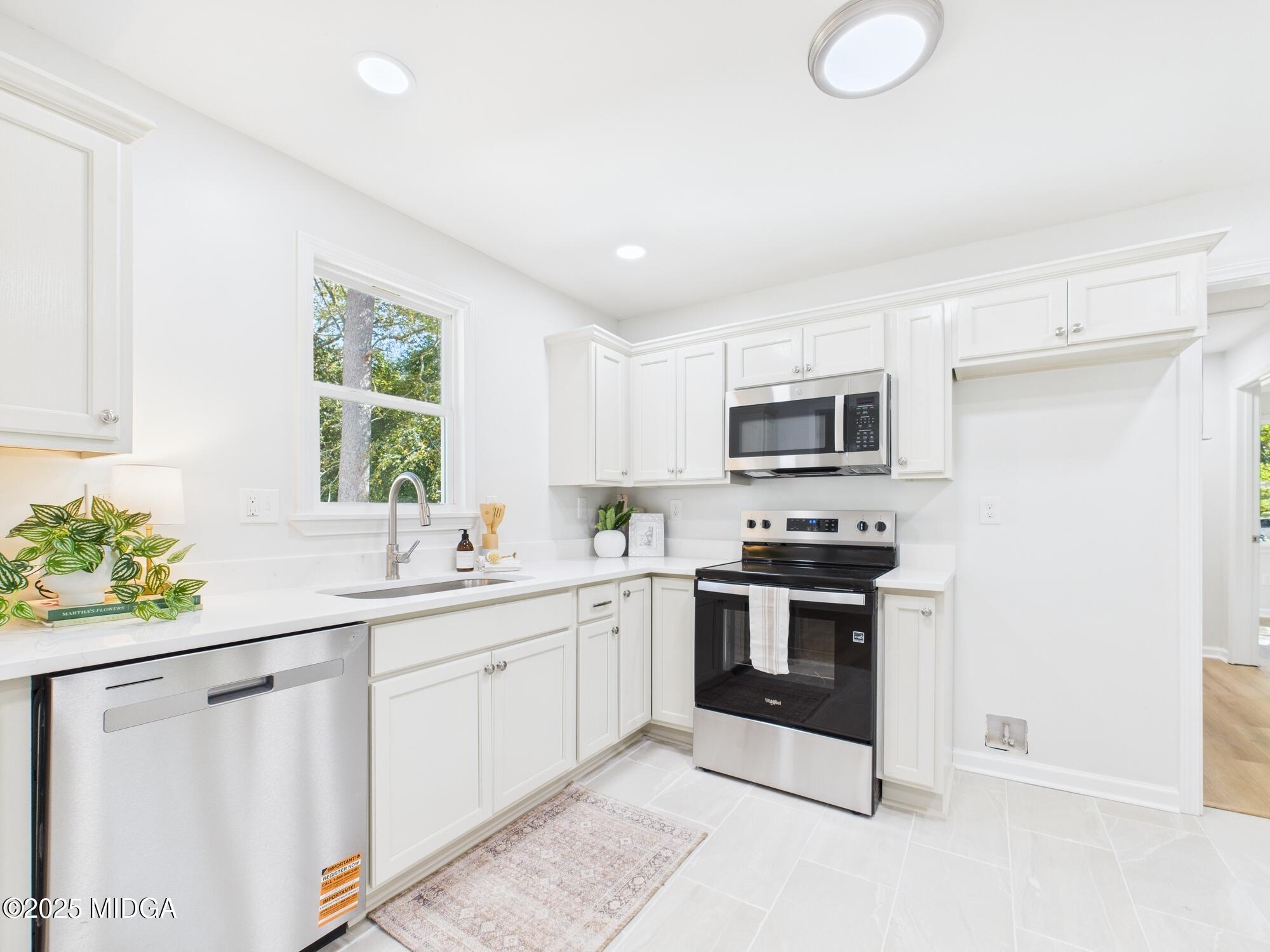 2471 Old Holton Road Macon, GA 31204 - Photo 9 of 34 a kitchen with stainless steel appliances granite countertop a stove a sink and a microwave