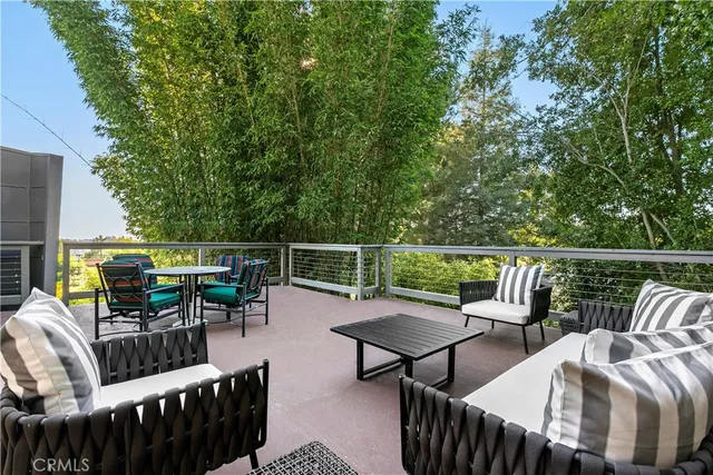 a view of a chairs and table on the deck
