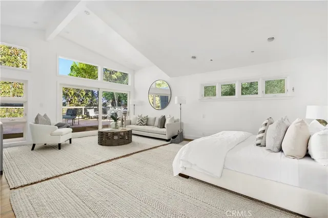 a bedroom with bed and a large window