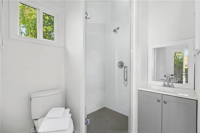 a bathroom with a toilet sink and shower