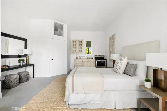 a bedroom with a bed and a couch