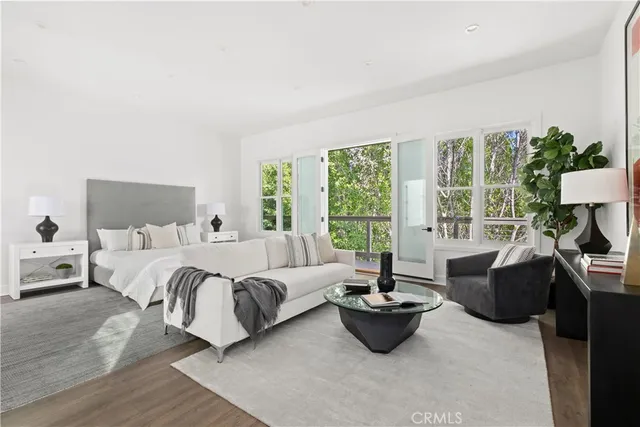 a living room with furniture and large windows