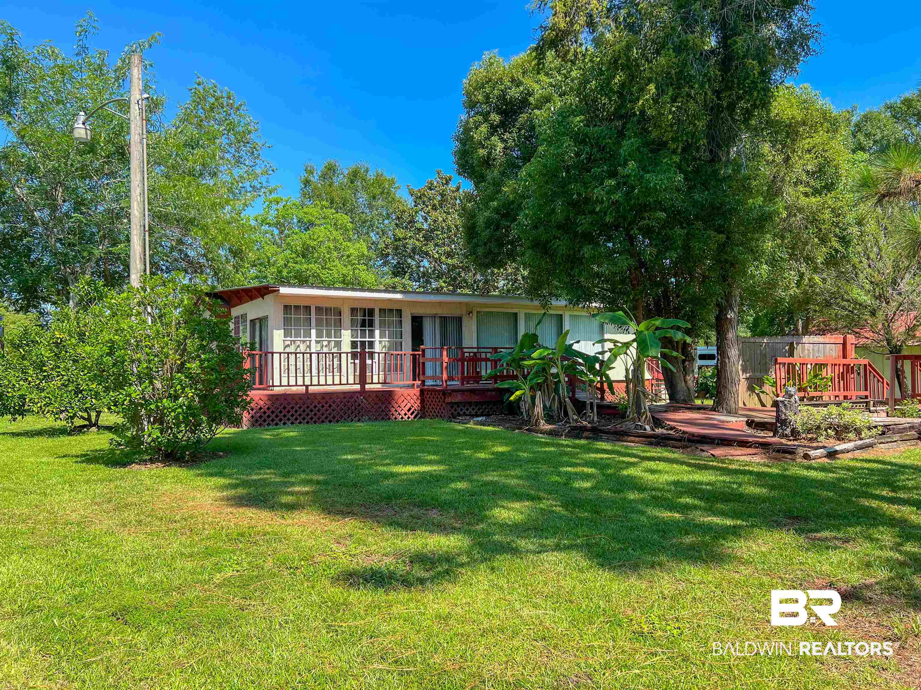 9190 County Road 97 Elberta, AL 36530 - Photo 12 of 53 Back of property featuring a deck and a yard