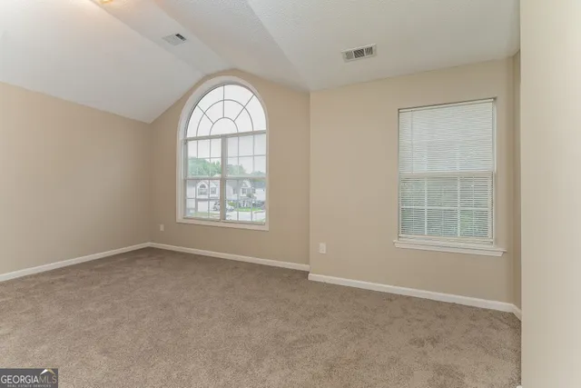 an empty room with windows mirror and windows