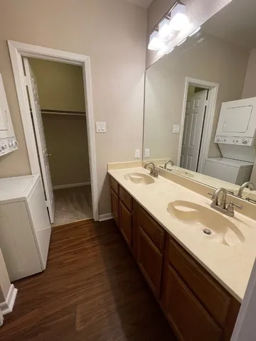a bathroom with a double vanity sink and a mirror