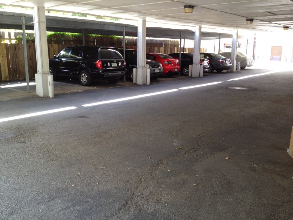 715 West 22 1/2 Street, Unit 201 Austin, TX 78705 - Photo 2 of 15 a view of cars parked in a parking