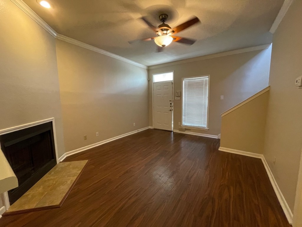715 West 22 1/2 Street, Unit 201 Austin, TX 78705 - Photo 5 of 15 a view of an empty room with wooden floor and a ceiling fan