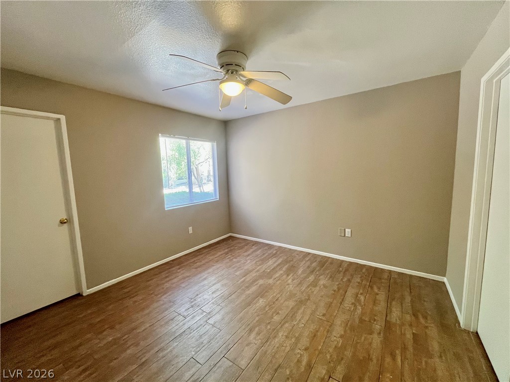 7885 West Flamingo Road, Unit 1029 Las Vegas, NV 89147 - Photo 11 of 18 Well-lit room featuring durable wood flooring and a refreshing ceiling fan.