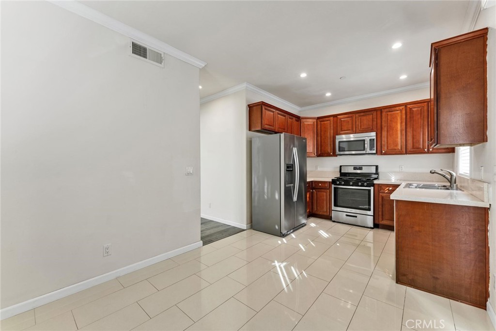 810 North Garfield Avenue Alhambra, CA 91801 - Photo 6 of 26 a kitchen with stainless steel appliances a refrigerator and a sink