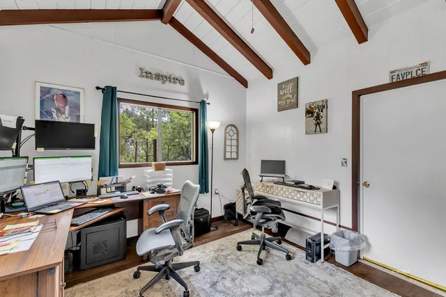 a view of a patio with table and chairs under an umbrella
