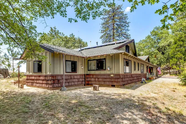 a view of a large room with wooden floor and iron stairs