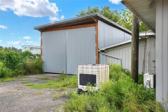 a view of a house with a small yard and plants