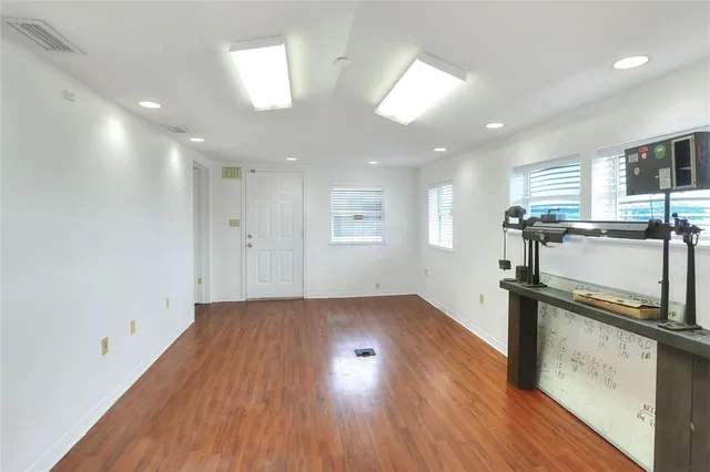 a view of a kitchen with a sink and wooden floor